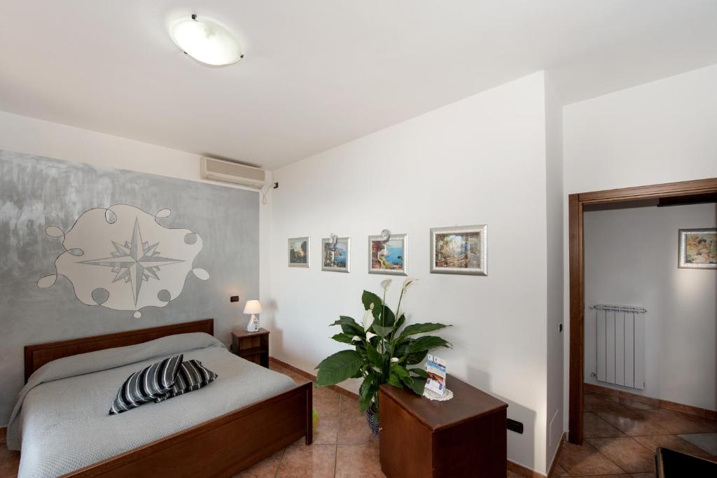 A bed or beds in a room at H.H.Le Palme