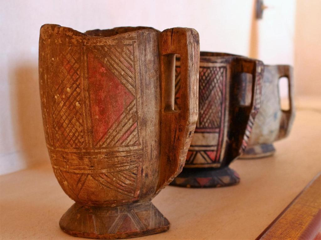 a group of brown vases sitting on a table at Hotel De Charme Les 3 Chameaux 4 étoiles in Mirleft
