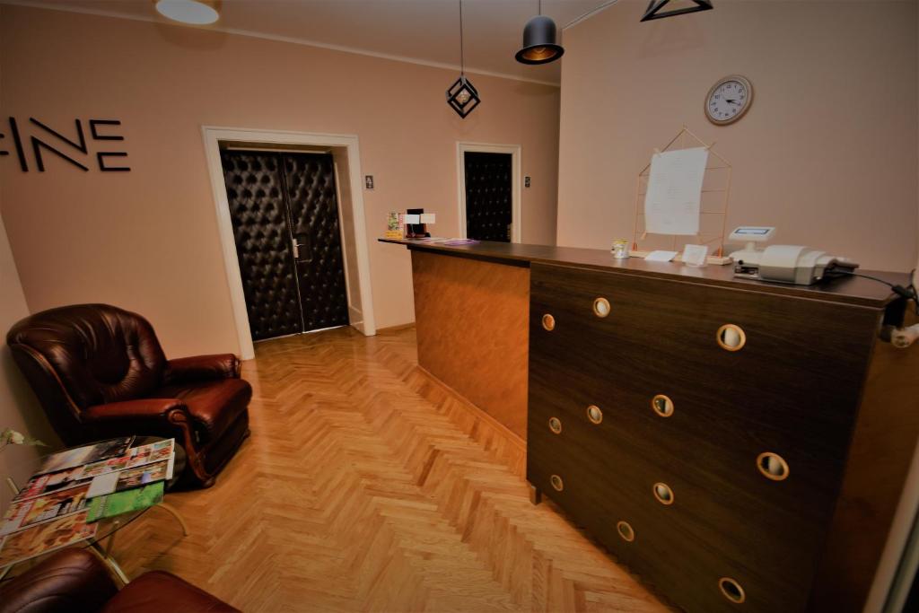 a living room filled with furniture and a tv at Hostel Fine in Belgrade