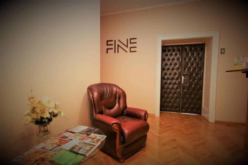 a living room with a leather chair and a table at Hostel Fine in Belgrade