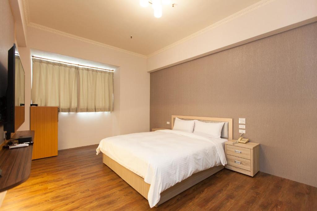Postel nebo postele na pokoji v ubytování Huang Tai Hotel