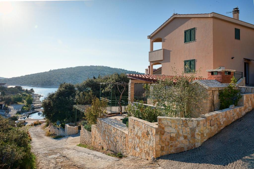 a house on a hill next to the water at Holiday Home Mirna Vala in Sevid