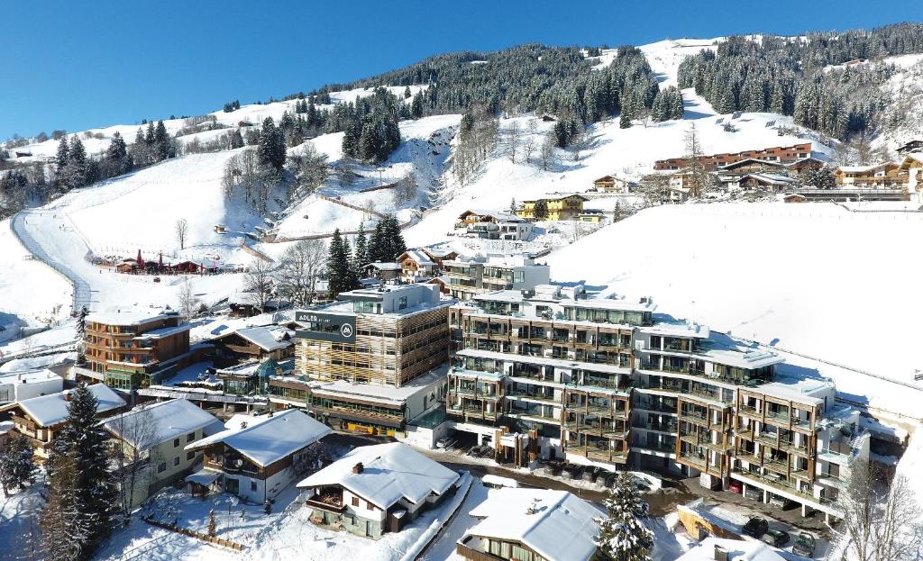 a snow covered mountain with a ski lodge at Adler Resort in Saalbach-Hinterglemm