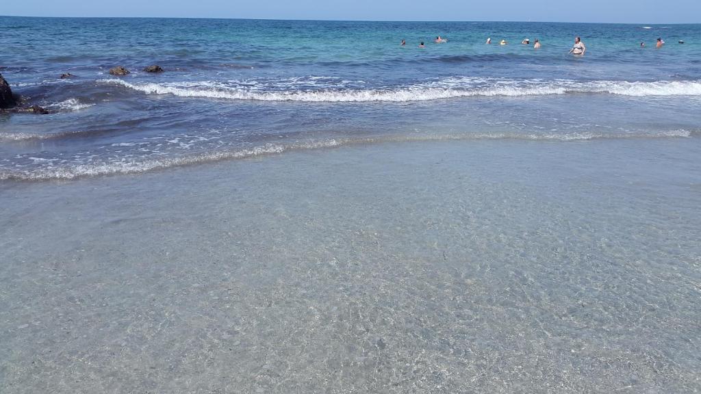 a group of people in the water at the beach at Ionian Green Villas in Preveza