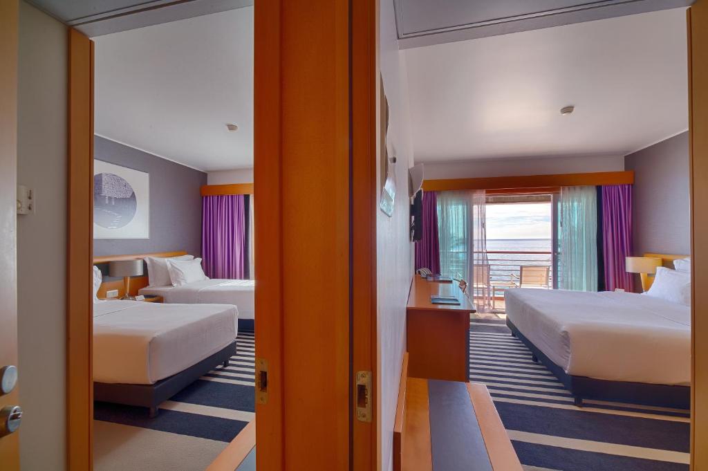 Uma cama ou camas num quarto em SANA Sesimbra Hotel