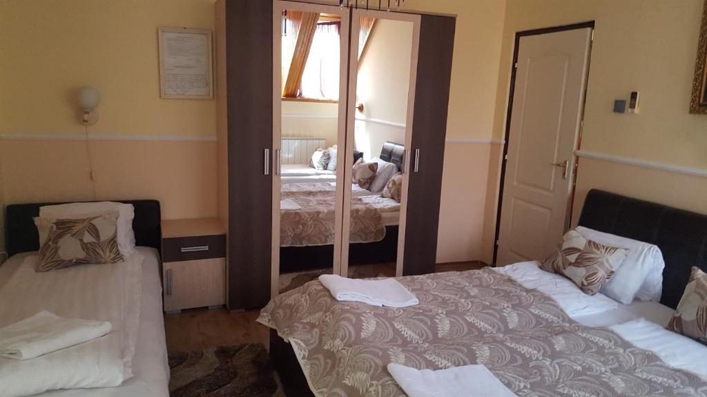 A bed or beds in a room at Parish Bull Hotel