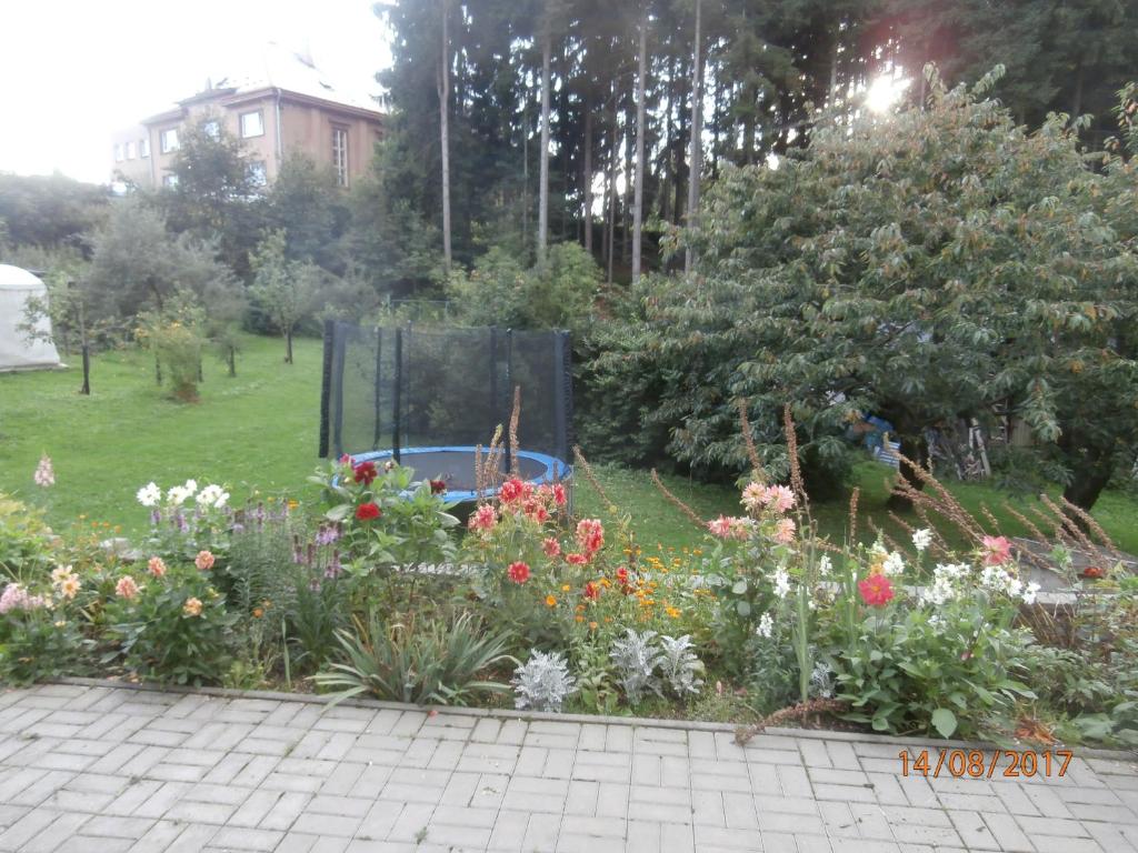 a garden with a bunch of flowers in a yard at Apartman Aya in Janov nad Nisou