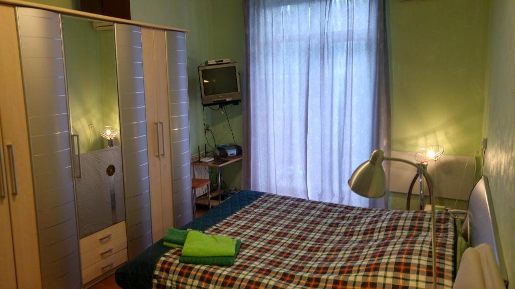 a small bedroom with a bed and a television at Shievchienko 10 in Kyiv
