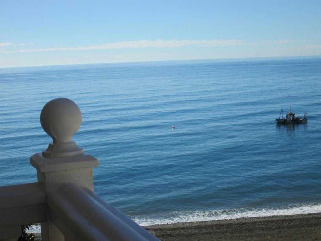 a view of the ocean with a boat in the water at Balcon del mar in El Morche