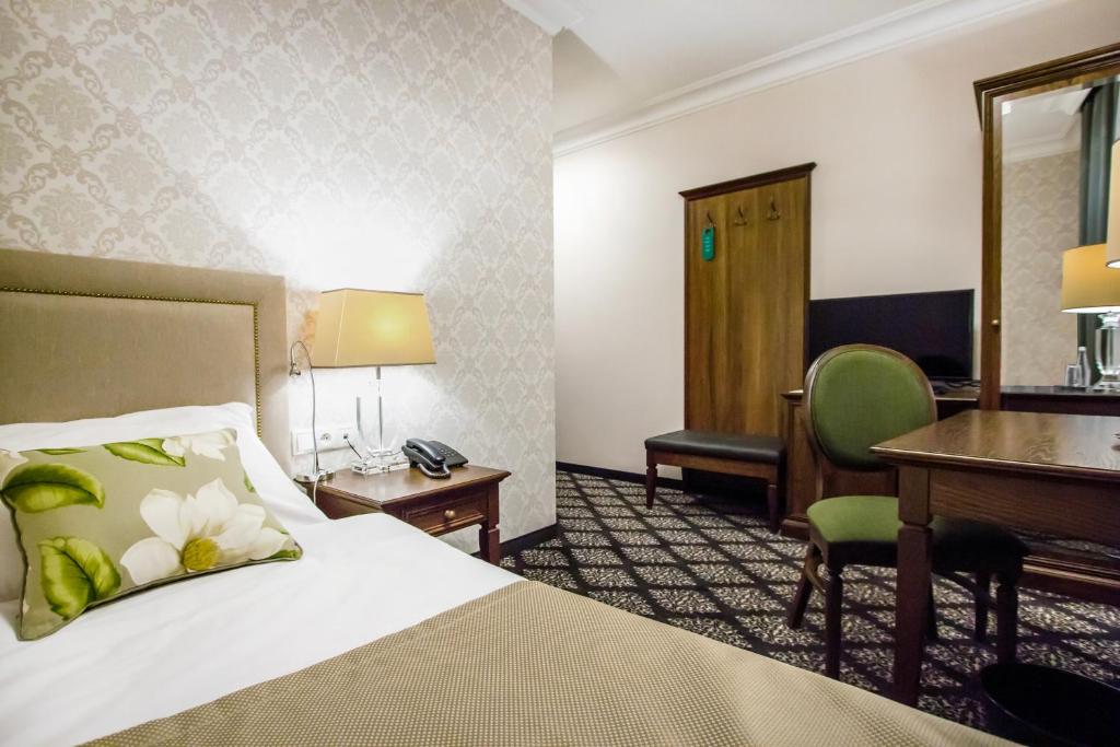 Postel nebo postele na pokoji v ubytování HG Hotel