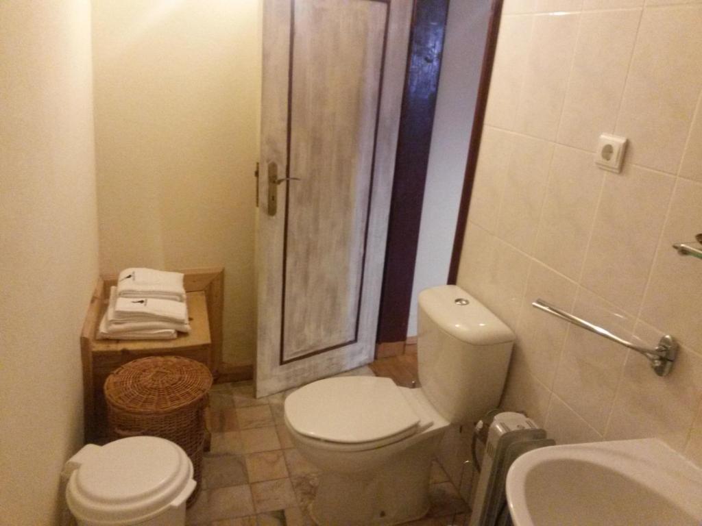 a bathroom with a toilet a sink and a bath tub at Casa das Freiras in Marialva