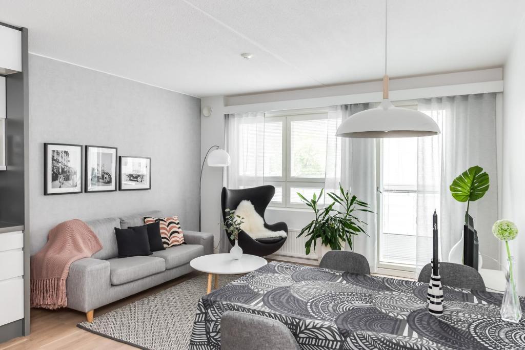 a living room with a couch and a table at Apartment Pohjanpoika in Oulu