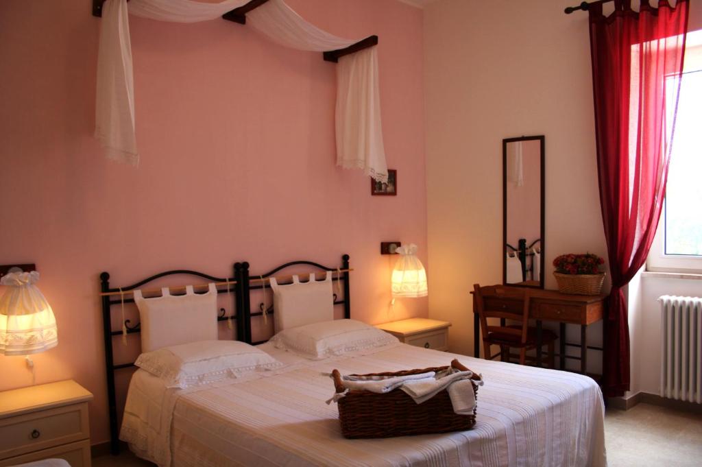 a bedroom with a bed with a basket on it at La Cascata in Noci