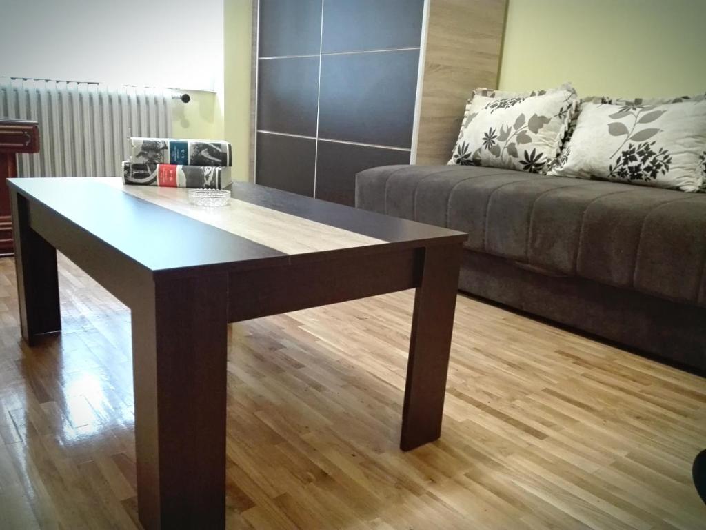 Apartment Jelena في بلغراد: طاولة قهوة في غرفة معيشة مع أريكة