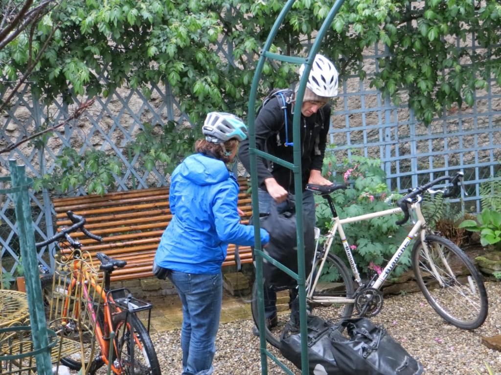 a man and a woman standing next to a bike at La Mirandole in Foix