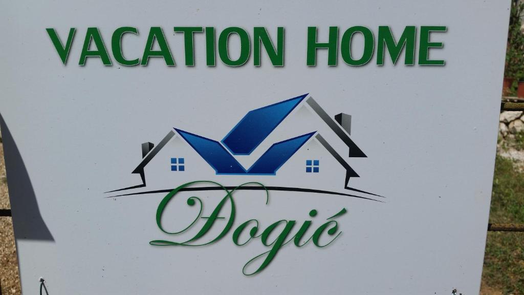 a sign for a vacation home in a house at Vacation home Djogic in Ilidza