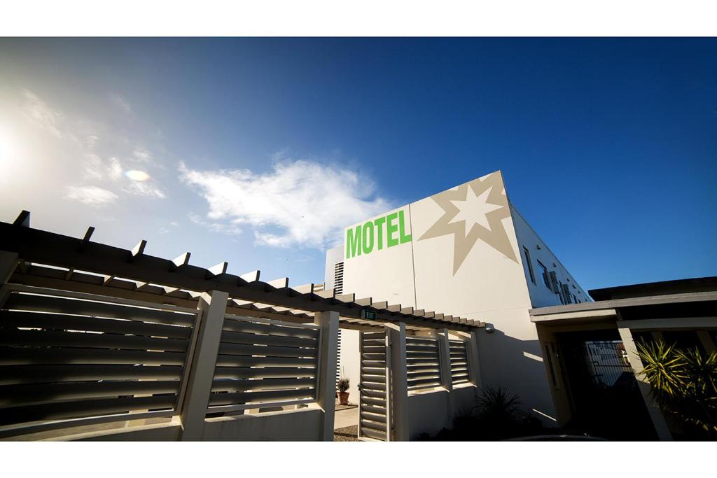 a building with a hotel sign on top of it at Northstar Motel in Oamaru