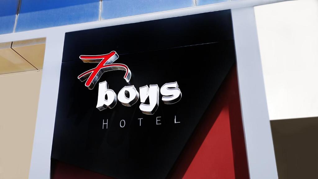 a sign for a bos hotel on a building at 7Boys Hotel in Amman