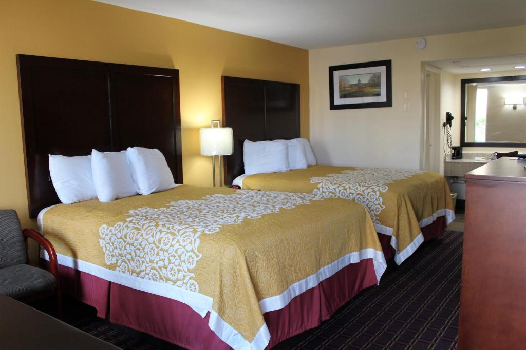 a hotel room with two beds and a bathroom at Bluegrass Inn in Frankfort
