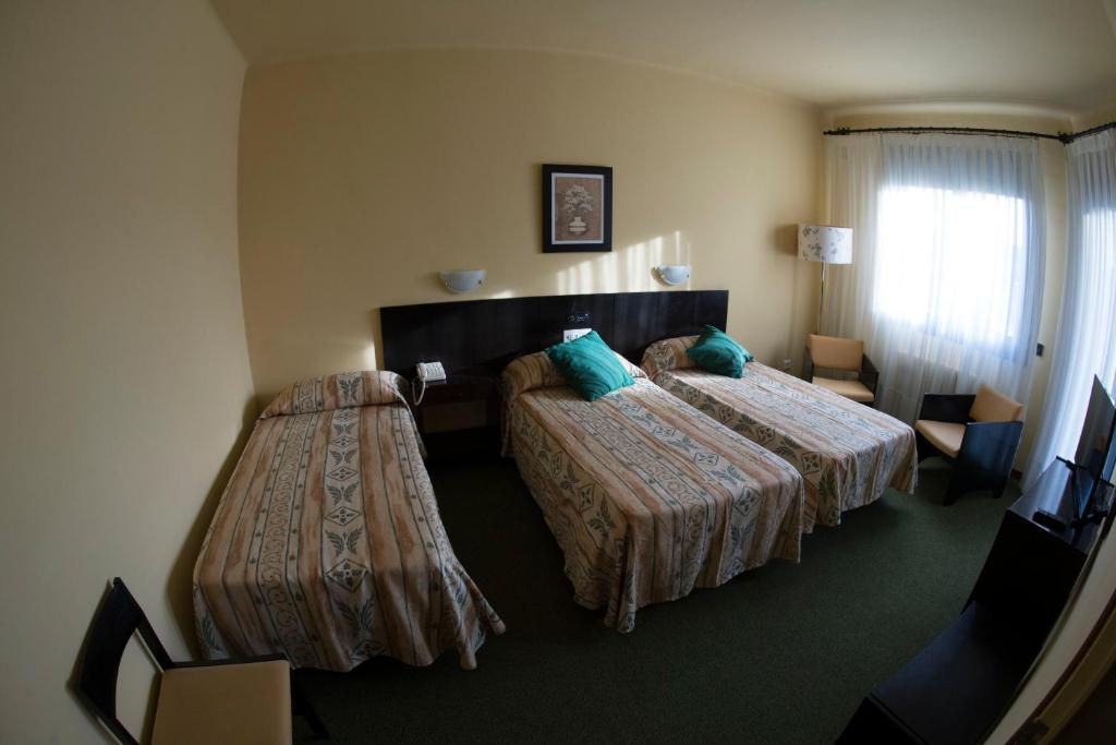 Postel nebo postele na pokoji v ubytování Hotel Gran Sol