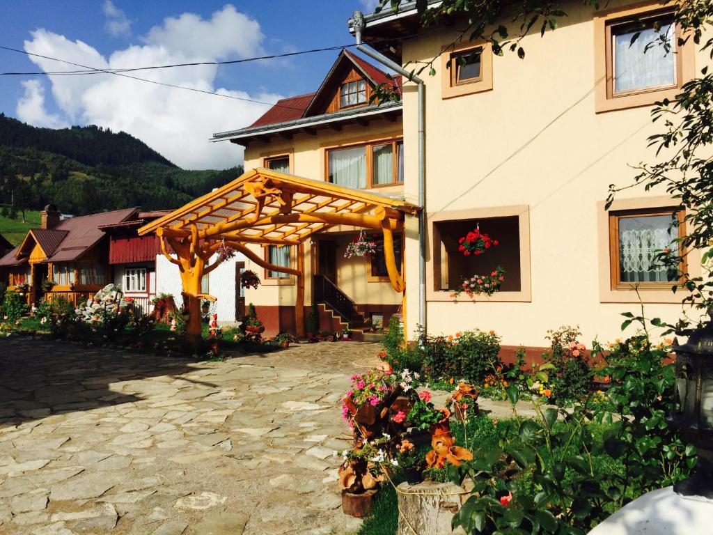 una casa con una pérgola de madera delante de ella en Casa Irinuca, en Sadova