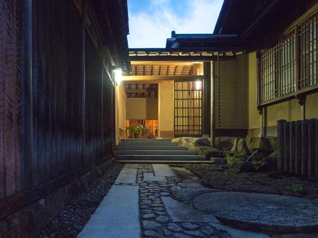 an entrance to a building with a stone walkway at SUKIYA-zukuri Suehiro in Hida