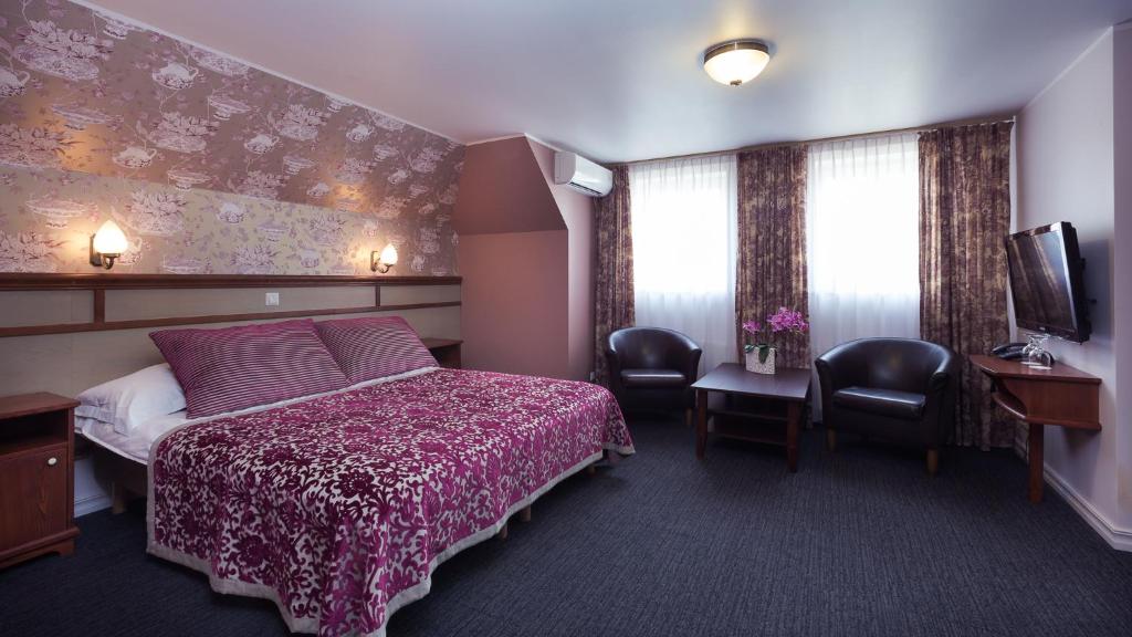 Postel nebo postele na pokoji v ubytování Hotel Villa Wesset