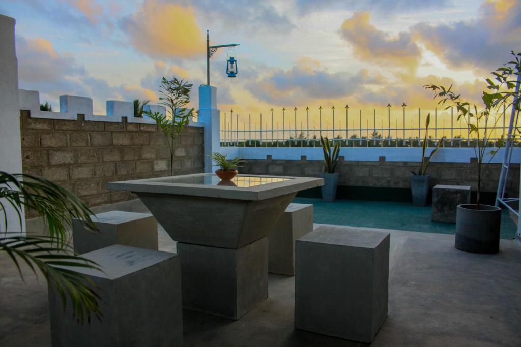 a patio with a table and a view of the city at Niwahana Transit City Hotel in Katunayaka