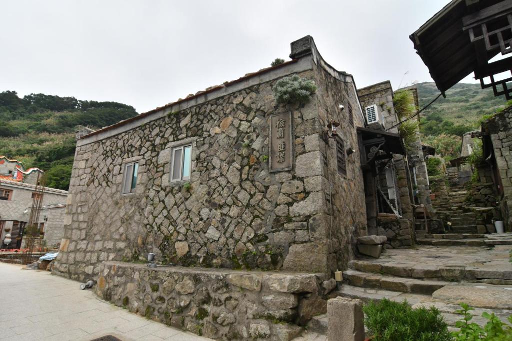 an old stone building with a stone wall at Chinbe D.S House 2 in Beigan