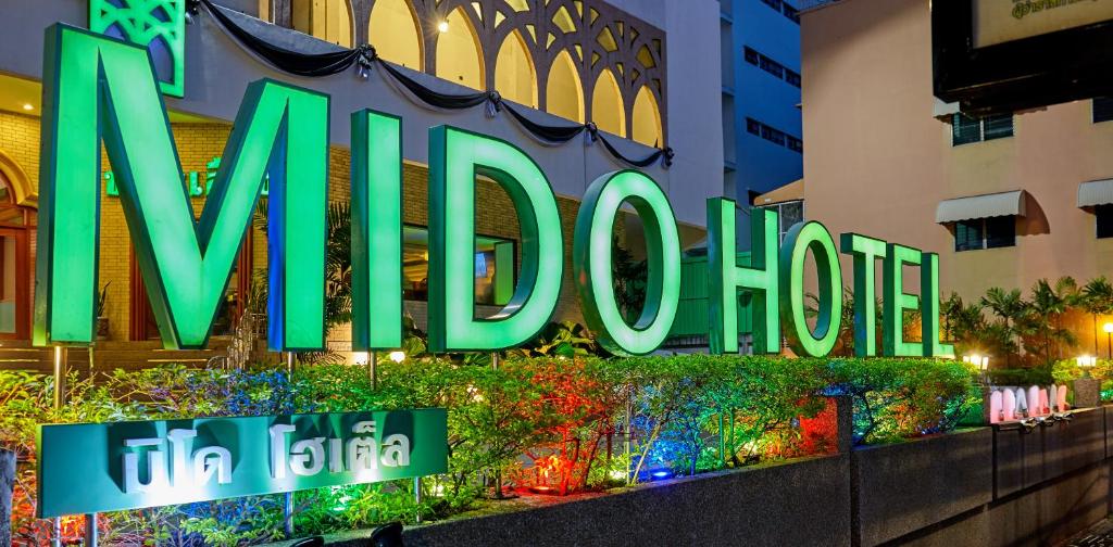 a lit up sign for the mgm hotel at MIDO Hotel in Bangkok