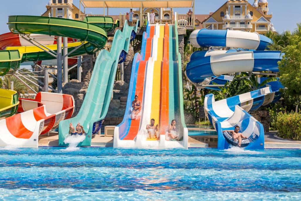 a group of children on a water slide at a water park at Royal Holiday Palace in Lara