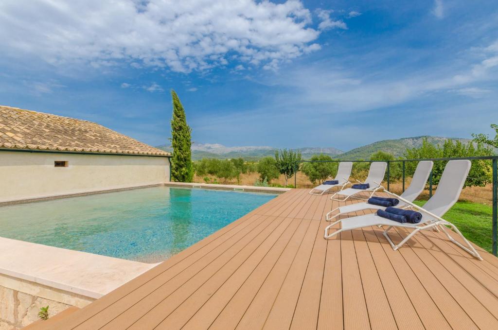 a deck with lounge chairs and a swimming pool at Son Sabater (Es Moli Nou) in Sa Pobla