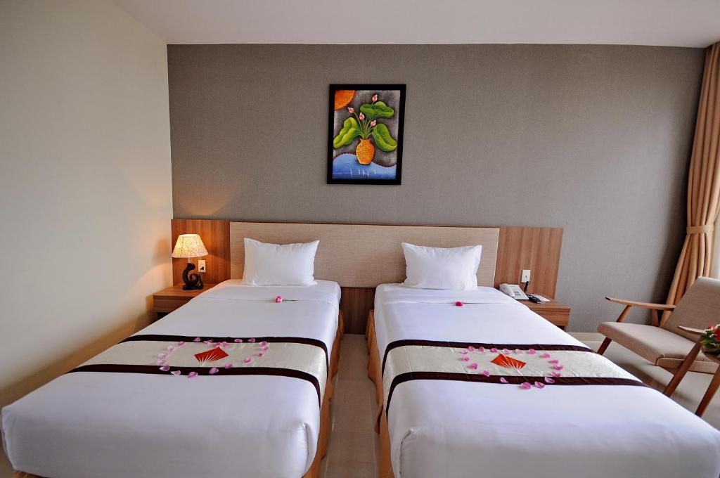 Postel nebo postele na pokoji v ubytování Rigel Hotel