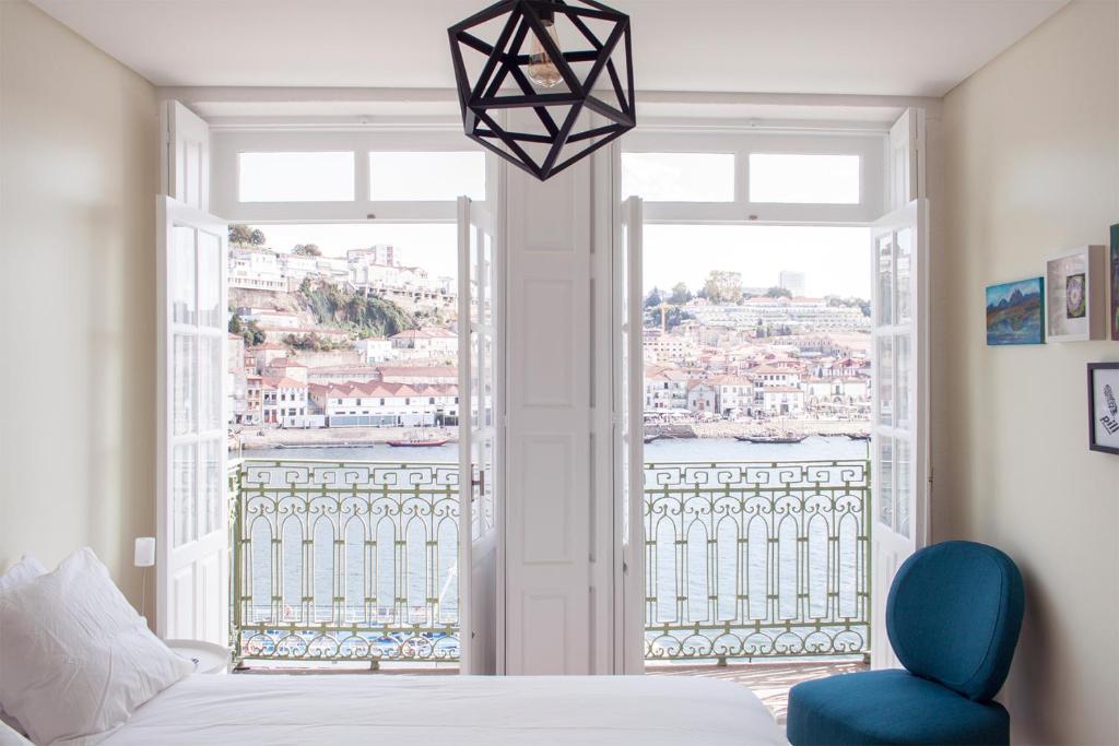 ポルトにあるPanorama Apartments Ribeira Portoのベッドルーム1室(ベッド1台、大きな窓付)