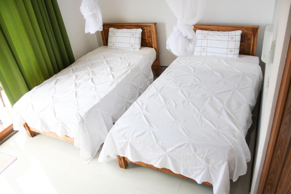 Postel nebo postele na pokoji v ubytování Elegant Home Stay