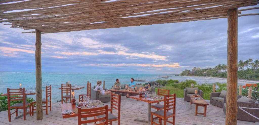 a restaurant on the beach with a view of the ocean at Matemwe Lodge in Matemwe