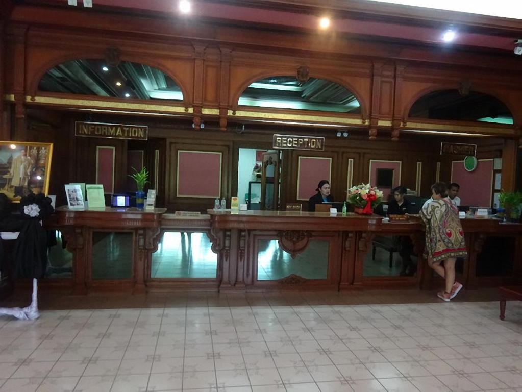 A wood-paneled reception counter with separate information and reception stations.