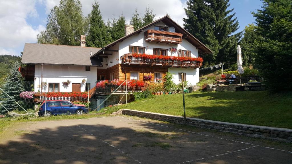 a house with a car parked in front of it at Ubytování Petrovičky in Mladkov