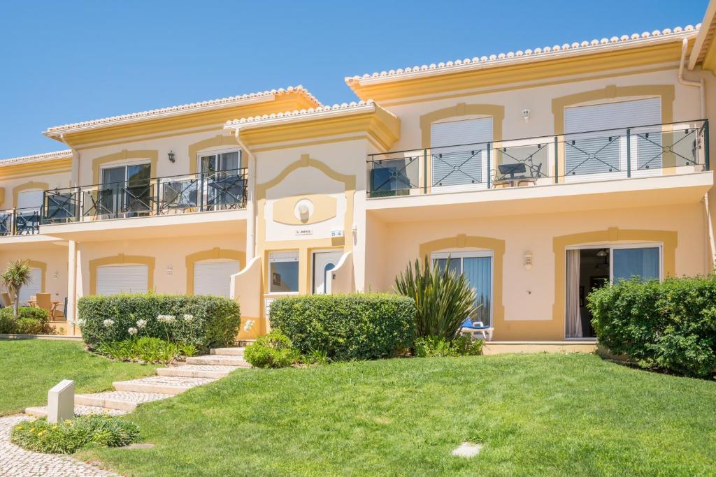 a large villa with a lawn in front of it at Boavista Fairviews Village in Lagos