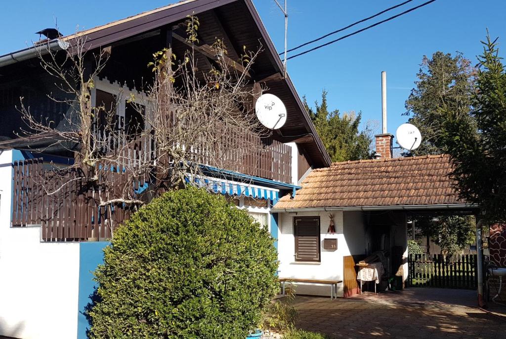 a house with clocks on the side of it at Apartment Labud in Legrad