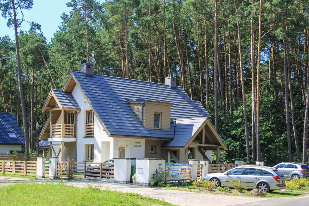 a house being constructed with a blue roof at Villa Arkadia in Łukęcin