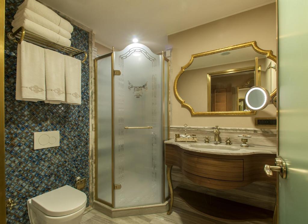 a bathroom with a sink and a toilet and a mirror at Romance Istanbul Hotel Boutique Class in Istanbul