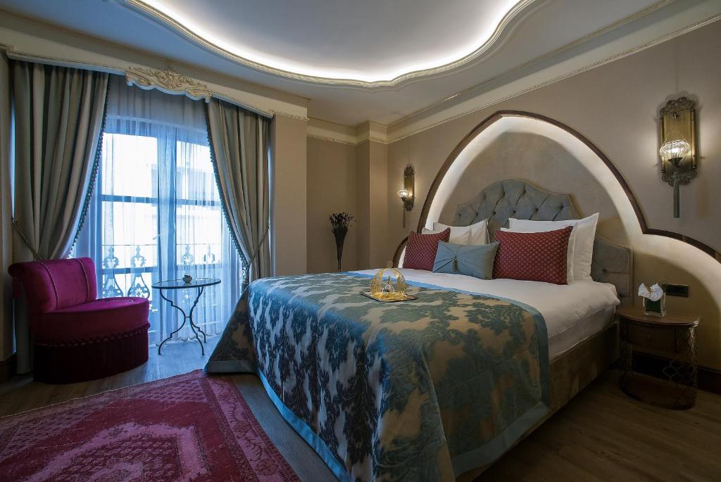 a bedroom with a large bed with an arch overhead at Romance Istanbul Hotel Boutique Class in Istanbul