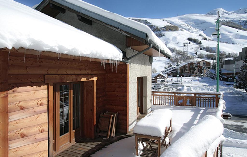 a cabin with snow on the roof of it at Odalys Chalet Le Marmotton in Les Deux Alpes