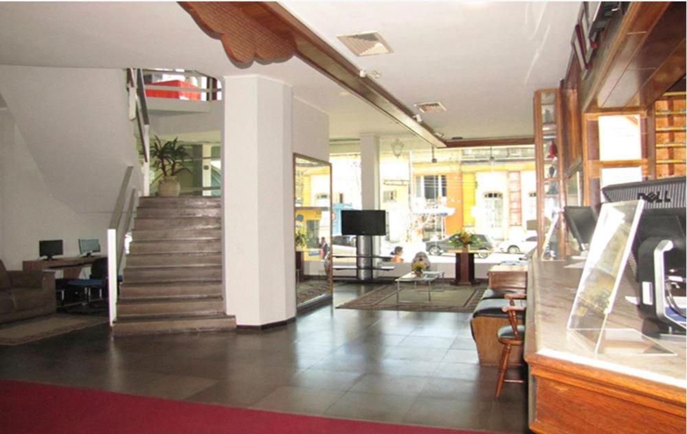 a lobby with a staircase and a living room at Hotel Portal in Santana do Livramento