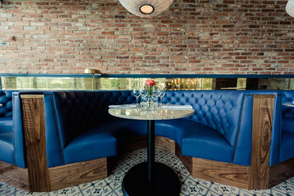 a blue bar with a table and a brick wall at Osprey Hotel in Naas