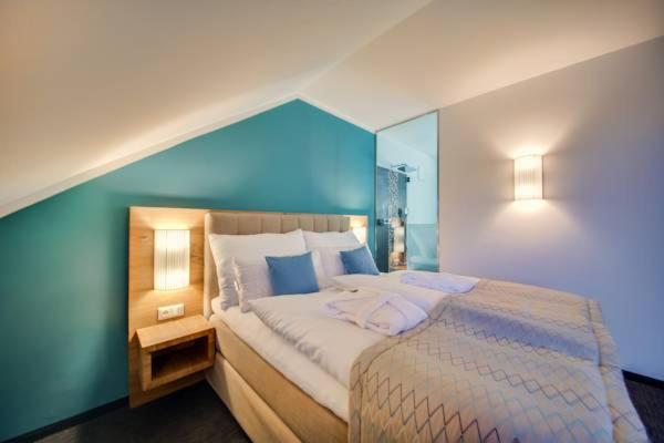 Postel nebo postele na pokoji v ubytování R&R Residenzen Aparthotel