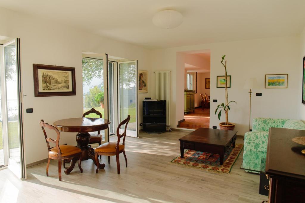 a living room with a table and a couch at Villa Paradiso in Camogli