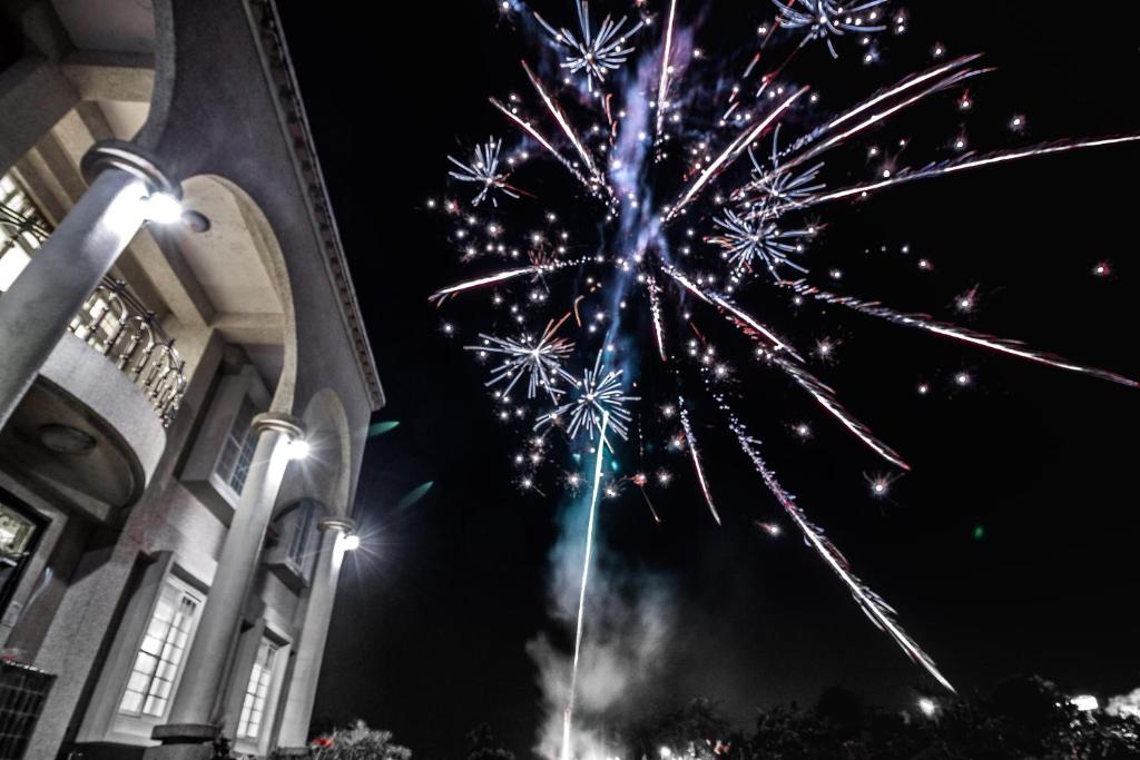 a fireworks display in front of a building at Star Shine B&B in Jiaoxi