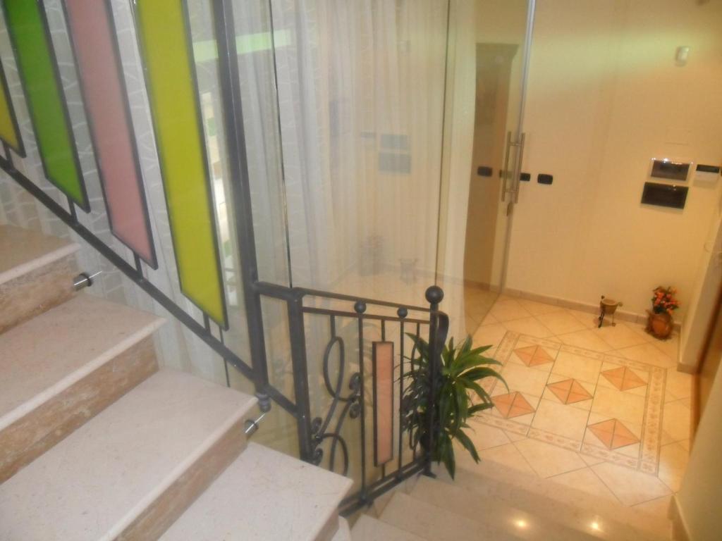 a bathroom with stairs and a shower and a plant at B&b La veduta in Corleto Monforte